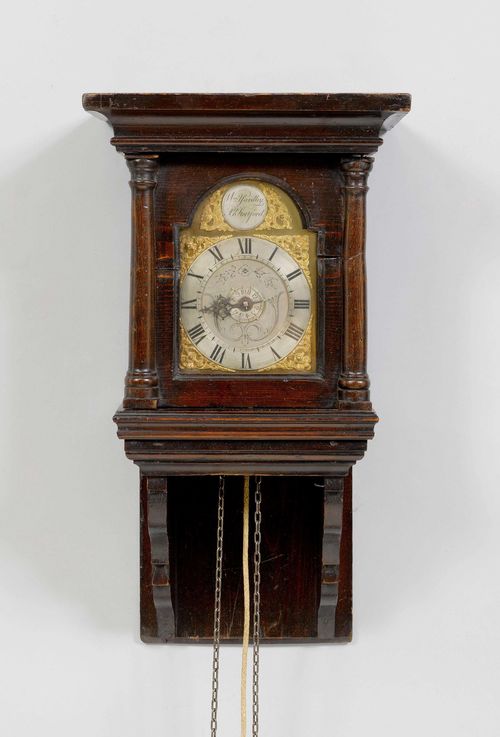 WALL CLOCK WITH ALARM,England, ca. 1780. The dial signed W.YARDLEY STORTFORD. Oak and pinewood, stained. Rectangular case on console. Brass fronton with silver-plated chapter ring. Movement with anchor escapement, and alarm on bell.. 29x22x53 cm.