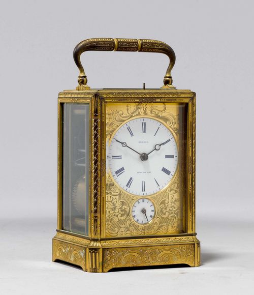 TRAVEL ALARM CLOCK, France, middle of the 19th century. The dial and the rear cover signed A. DEMEUR HGER DU ROY. Gilt, brass engraved with scrolls and tendrils. Rectangular case with handle, glazed on three sides. Engraved brass fronton, white enamel dial and small alarm dial. Movement with balance, striking mechanism striking the 1/2-hour on bell. Alarm on bell. 8x7x13 cm. 1 key. Gilding rubbed, striking mechanism requires revision.