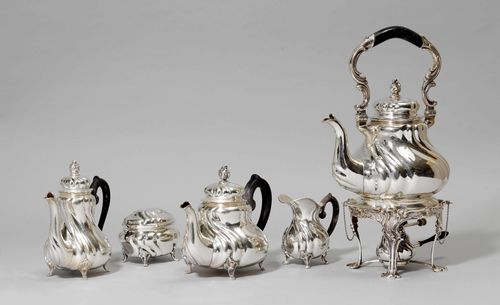 TEA AND COFFEE SERVICE,Germany, 19th/20th century. Manufactory mark: Hermann Behrnd. Comprising: hot water pot and rechaud, teapot, coffeepot, sugar bowl and cream jug. Walls with curved folded tongues. Curved wooden handle. H of the coffeepot 21 cm, total weight ca. 4250 g.