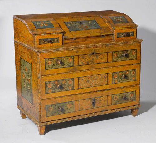 PAINTED BUREAU CABINET,Biedermeier, from the Alpine region. Pinewood, painted with flowers in rectangular reserves on a partly faux-marble ground. Rectangular body. Slightly retracted upper part with tilted, hinged writing surface with a drawer on each side. Tapered feet. The writing surface opens up into 1 compartment and 4 drawers. Lower part with three drawers. 120x57x109 cm.