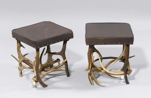 PAIR OF ANTLER STOOLS,in the style of the Alpine region, 20th century. Rectangular, padded seat on an antler frame. Brown leather cover. 43x 43x47cm.