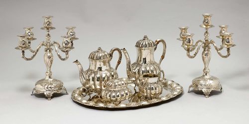 COFFEE AND TEA SET,Germany, 20th century. With maker's mark. Comprising: 2 candlesticks with five light branches, coffee pot, tea pot, sugar bowl, cream jug, tray. Insulating rings, in part missing or replaced. H of the coffee pot ca. 24 cm, total weight 5870 g.