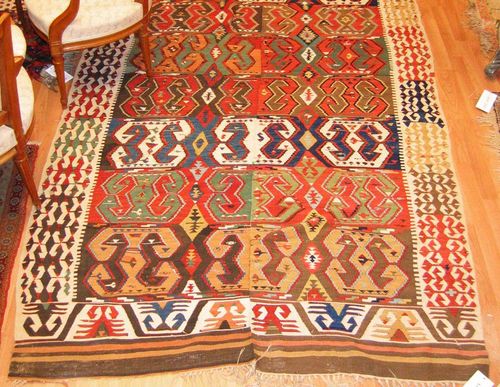KILIM antique. Horizontally striped central field with a geometric pattern in harmonious colours, white border, slight wear, 295x155 cm.