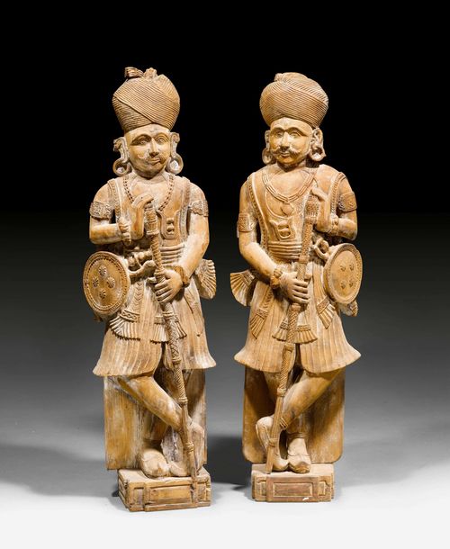 TWO CARVED WOOD FIGURES OF STANDING PALACE GUARDS. India, Goa, Indo-Portuguese style, Height 142 cm. (2)