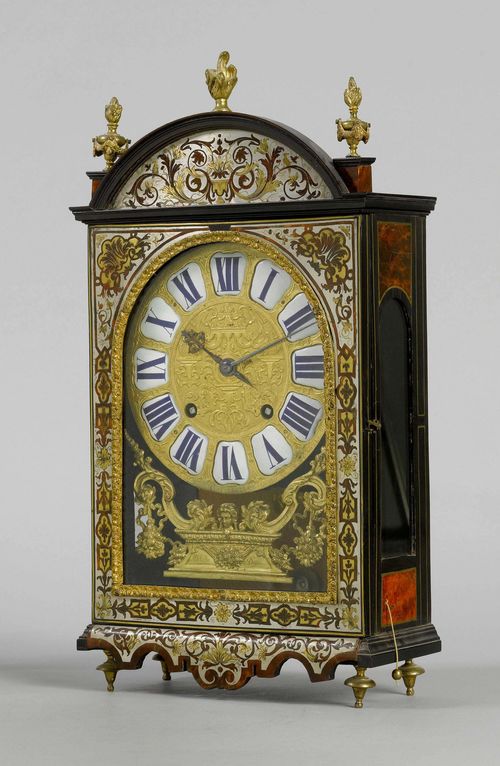 MANTEL CLOCK WITH BOULLE MARQUETRY,Louis XIV, the dial signed MICHELIN À DIJON, the movement signed. GRIBELIN À PARIS. Rectangular case with Boulle marquetry in red tortoiseshell, brass and tin, with trailing flowers and leaves. Bronze dial with white enamel cartouches. Movement with verge escapement striking the 1/2-hour on 3 bells. Repeater. H 55 cm.