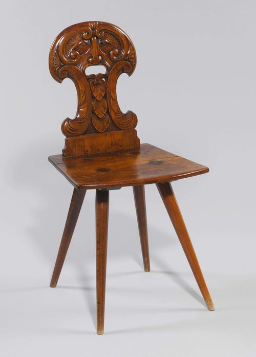 STABELLE WITH GROTESQUE FACE, Renaissance style, Switzerland. Walnut, carved with mask and leaves. Trapezoid seat on inclined legs. Curved backrest with pierced handle.