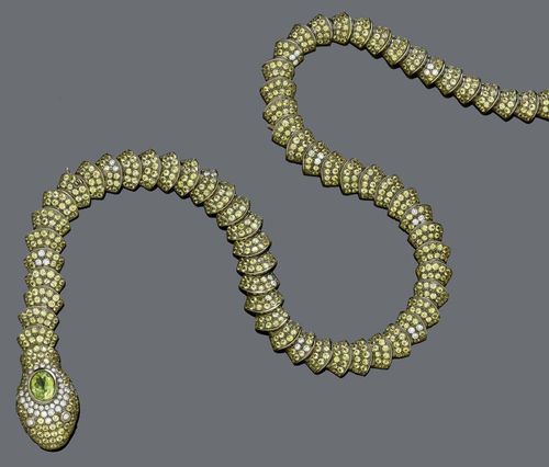 SAPPHIRE, DIAMOND AND PERIDOT NECKLACE. Gold 750, black rhodinized. Very decorative Y-necklace in the shape of a snake, with flexible, scale-like graduated links, set throughout with 1281 yellow sapphires weighing ca. 43.80 ct, and 83 brilliant-cut diamonds weighing ca. 2.37 ct. The head additionally decorated with 1 oval peridot of ca. 2.00 ct. L closed ca. 43 cm. L of the entire snake ca. 63 cm.