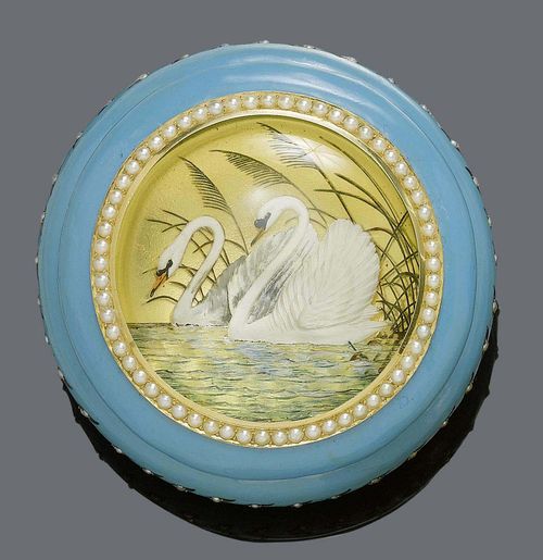 ENAMEL AND PEARL MINIATURE POWDER BOX, PRESENT OF LUDWIG II, ca. 1882. Yellow gold and silver. Round box with a light blue enamelled wall, decorated with a wave-like line of leaf motifs with Oriental half-pearls. The cover has a pearl border set with a rock crystal, which is engraved on the back, and depicts 2 swans swimming in a pond. The bottom has a polychrome enamel miniature, decorated with the royal coat of arms of the Wittelsbacher floating in the sky in front of a royal cloak carried by two angels and two cherubs, above a floating cherub holding the crown.. Enamel partly restored. Ø ca. 6.4 cm, H 3.6 cm. With case by Peter Rath, purveyor to the Court, Munich.