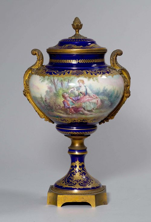 LIDDED VASE WITH BRONZE MOUNT,Napoleon III. Porcelain in the style of the Manufacture de Sèvres, bronze from the 19th century, Paris. Round vase with bronze mounts. Walls decorated with a gallant scene and 2 putti. H 54 cm. Provenance: - from an Italian private collection.