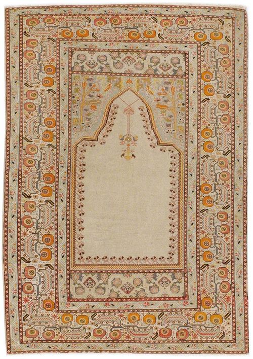 GHIORDES antique.Beige mihrab with light blue spandrels, broad border in white, decorated with trailing flowers, signs of wear, 180x130 cm.