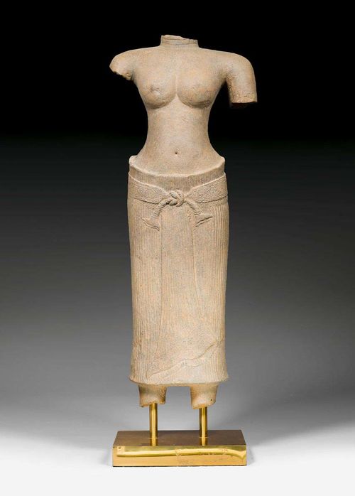 A FINE GREY STONE TORSO OF A FEMALE DEITY. Khmer, early style of Angkor Wat, first half of 12th c. Height 74 cm.