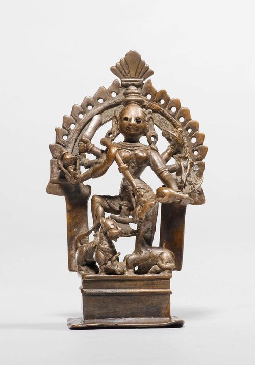 A BRONZE FIGURE OF DURGA SLAYING THE BUFFALO DEMON. India, ca. 18th c., height 12.5 cm. One inlaid eye lost.