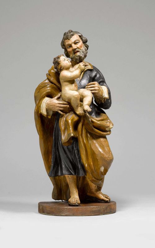 SAINT JOSEPH WITH THE CHILD JESUS,Baroque, Southern Italy, circa 1700. Wood, fully carved in the round and painted. Glass eyes.  H 50 cm. Mounted on a later flat plinth. The painting of a later date and brittle. Provenance: Private Zurich collection.