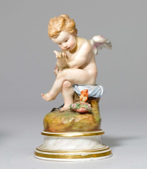 SEATED CUPID WITH HEART,Meissen, ca. 1880. Cupid seated on a round base, a flaming heart at his feet. Underglaze blue sword mark. Incised Model No. H 17.5 cm. Restored.
