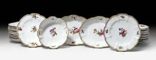 PIECES OF A DINING SERVICE 'GOTZKOWSKYS ERHABENEM BLUMENDEKOR', Höchst, ca. 1765. Designed after a model from Meissen. Curved border with gilt edge, painted with five small flower bouquets. Comprising: 23 plates, 2 oval platters, 1 bowl. Underglaze blue mark. (26) Provenance: - from a private collection, Geneva.