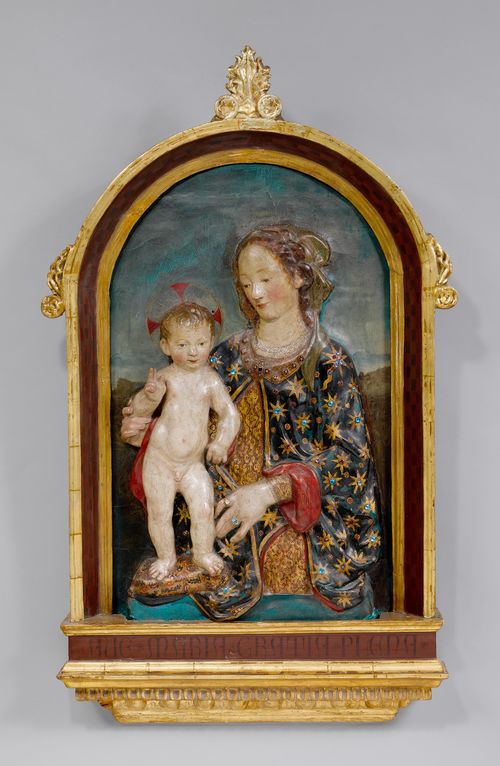 RELIEF WITH MADONNA AND CHILD,Renaissance, Florence, 16th/17th century. After depictions by Andrea del Verrocchio. Wood and papier-mâché, painted and decorated with glass stones. Mary wearing an extravagant gown, presenting the Christ Child standing and raising his hand in blessing. In a later frame. H 84 cm. Different layers of paint.