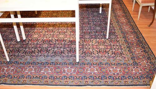 TABRIZ antique. Dark central field finely patterned with flowers and palmettes in harmonious colours, red border, signs of wear, 410x310 cm.