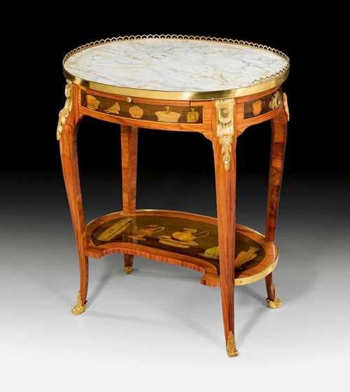OVAL GUÉRIDON, Louis XV, stamped C. TOPINO (Charles Topino, maitre 1773), Paris circa 1775. Tulipwood, rosewood and partly dyed precious woods in veneer also finely inlaid with cups, vessels, feathers and frieze. The "Carrara" top edged in a pierced brass rail, one leather-lined sliding ledge at the front and 1 drawer at the side. Gilt bronze mounts and sabots. 60x41x72 cm. Provenance: - Galerie Gismondi, Paris. - from a highly important Eurpean collection. A fine guéridon in very good condition.