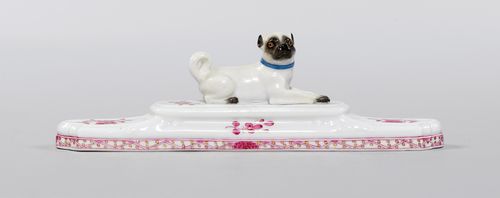 PAPERWEIGHT WITH PUG,Meissen, 19th century. Rectangular, painted with Indian flowers in purple, the centre with a reclining pug. Underglaze blue sword mark, model number 1645 incised, press number, L 19 cm.
