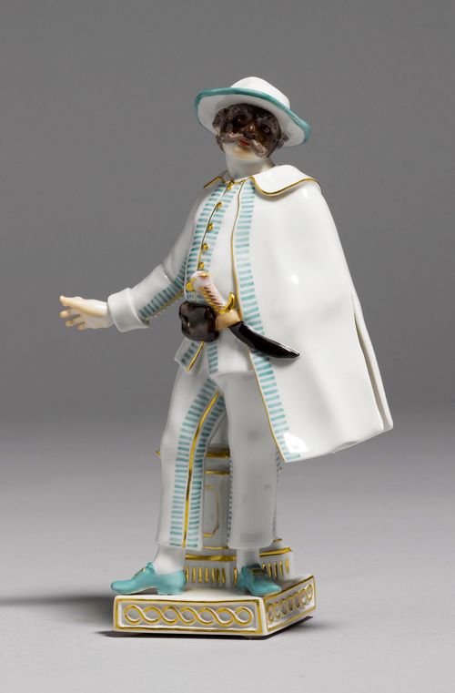 COMEDY FIGURE,Meissen, from a series of the Commedia dell'Arte, modern. The face covered with a black mask, wearing a white costume with a sea-green border and gold edging, with a dagger in his belt. Underglaze blue sword mark, model number 64560 impressed and impressed mark 15 with mark for the year. H 17 cm.