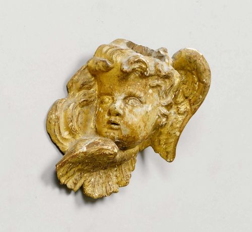 WINGED HEAD OF AN ANGEL,Northern Italy, beginning of the 18th century. Wood carved, verso flattened and gilt. H 20 cm. Rubbed.
