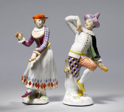 TWO SMALL FIGURES OF A MALE AND FEMALE HARLEQUIN,Meissen, 20th century. Male figure wearing a lozenge-patterned costume, a pointed cap, a white jacket with a ruff, a black cloak and knickerbockers, and holding a slapstick in his left hand. Dancing female figure wearing a purple vest, a white dress with a lozenge-patterned hem and a red hat. Underglaze blue sword marks, model numbers 64527 and 64517 impressed. H 14.7 cm and 14 cm. (2)