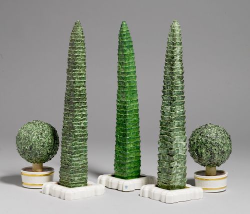 5 PORCELAIN TREES AS TABLE DECORATION,Nymphenburg, 20th century. Comprising: 3 pyramid-shaped trees and 2 small spherical shrubs, naturalistically modelled and painted in green, on a white base. Impressed shield mark, impressed green shield mark and Nymphenburg. H 13 and 33 cm. (5)