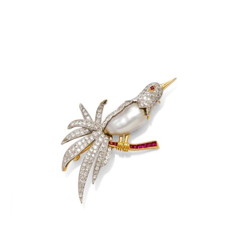 PEARL, DIAMOND AND RUBY BROOCH. Yellow gold 750, 19 g. Designed as a bird of paradise perched on a branch, the body set with 1 Baroque, South Sea cultured pearl of ca. 18 x 10 mm and numerous brilliant-cut diamonds weighing ca. 1.50 ct. The branch additionally decorated with 8 square-cut rubies weighing ca. 0.10 ct. Ca. 6.5 x 3.8 cm.