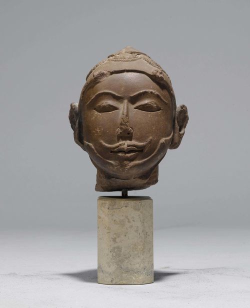 A SANDSTONE HEAD OF A KING. Central India, 10th/11th c., height 19 cm. Headgear broken off. Old Swiss private collection.