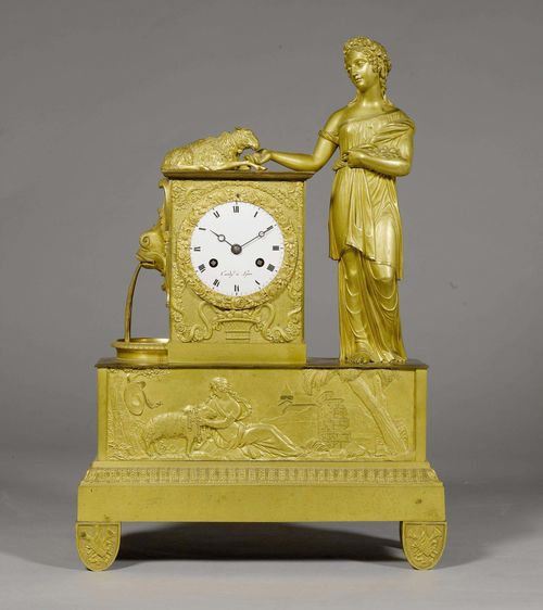 MANTEL CLOCK, Restoration, France, ca. 1830.The dial signed CARDY À LYON. Gilt bronze and brass. Rectangular case with female figure and sheep symbolizing loyalty and love. The plinth with a raised pastoral scene. White enamel dial. Paris escapement striking the 1/2-hour on bell. H 43 cm. Serviced.