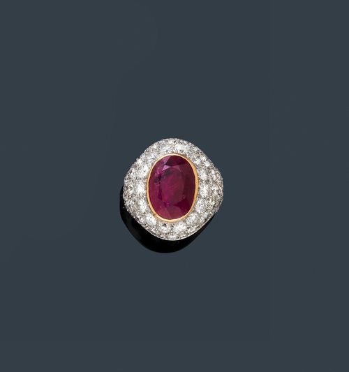RUBY AND DIAMOND RING, France, ca. 1980. White and yellow gold 750. Casual-elegant ring, the convex top set with 1 treated, oval ruby weighing ca. 4.50 ct, and pavé-set with numerous brilliant-cut diamonds weighing ca. 3.50 ct. Size ca. 53, with size adjustment insert. With case. Oral short report by GGTL/Gemlab.