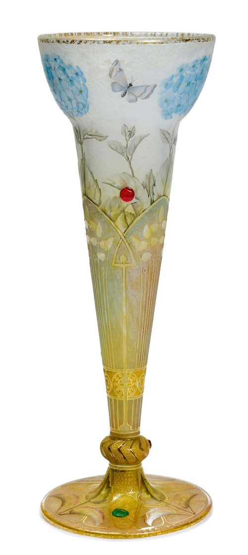 DAUM NANCY VASE, c. 1900 White glass with etched, enamelled and applied decoration in the form of hydrangeas and butterflies, with applied cabochons in red and green. Signed Daum Nancy. H. 39 cm.