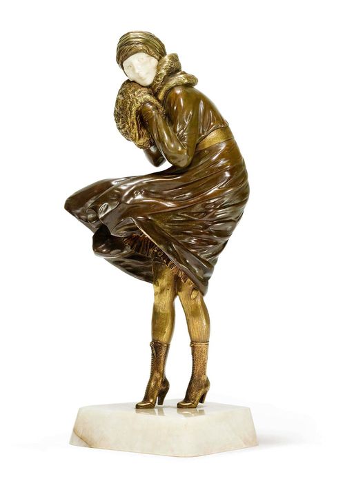 DEMETER H. CHIPARUS (1888-1950) SCULPTURE "The Squall", c. 1920 Bronze with brown patina and carved, gilt ivory. Young lady on a white onyx plinth. Signed Chiparus, Bronze Etling Paris. H. 31.5 cm.