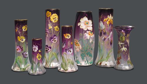 Attributed to LEGRAS LOT OF 7 VASES, circa 1900 White and violet glass, enamelled. Different shapes decorated with flowers. H 19 cm to 36 cm.