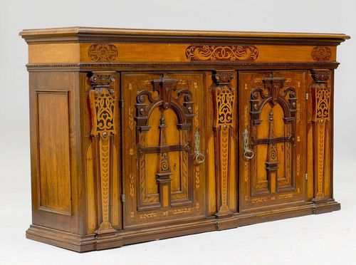 SIDEBOARD, in the Renaissance style, Switzerland, in part using old elements. Walnut and fruitwoods inlaid with bands, mythological creatures and friezes. Architecturally structured front with 2 panelled doors. Metal escutcheons. 186x52x103 cm. 1 key. According to Pierre Koller, these inlays are typical for the Art Nouveau style.