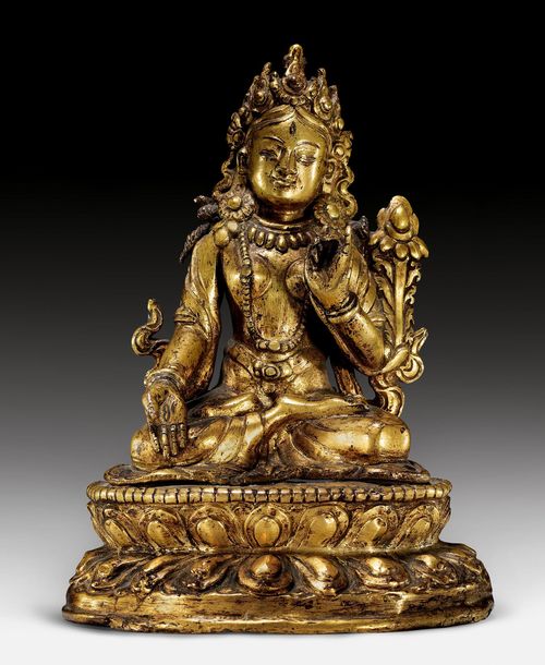 A PARTLY GILDED COPPER-ALLOY FIGURE OF WHITE TARA ON A REPOUSSÉ BASE. Nepal, 17th/18th c. Height 14.8 cm.