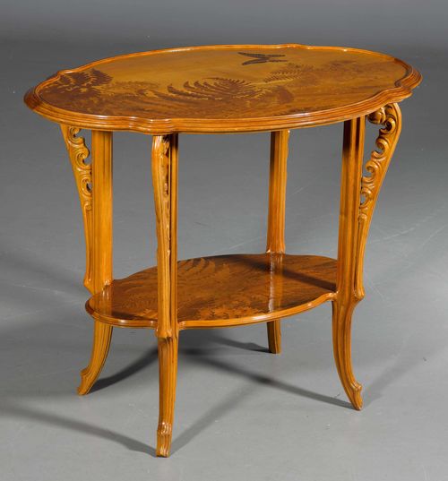 EMILE GALLE SIDE TABLE, ca. 1900. Walnut, carved and inlaid with fruit woods. Oval table with curved rim. Top inlaid with fern decorations and a butterfly. The legs are carved as ferns. Signed Gall&#233;. H 75 cm. L 91 cm. Duncan/De Bartha, &quot;Gall&#233; Furniture&quot;, page 156. Philippe Garner, Gall&#233;, Edition Flammarion, 1976, page 85.