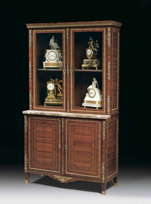 VITRINE, Louis XVI, attributed to C.C. SAUNIER (Claude Charles Saunier, Master 1752) Paris circa 1780. Tulipwood, rosewood and various precious woods in veneer and inlaid with fillets and frieze. With two-door lower section and internal hinged drawer with writing compartment,  with vitrine superstructure and "Fleur de Pêche" top. With rich gilt bronze mounts, sabots and applications.  120x46x213 cm.