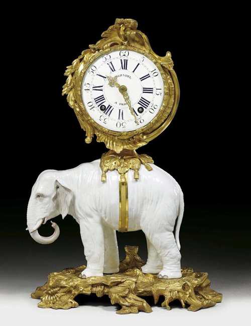 PENDULE "A L'ELEPHANT BLANC", Louis XV, the dial and movement signed BLONDEL A PARIS (Nicolas Blondel, maitre 1746), the bronzes probably by J.J. DE SAINT-GERMAIN (Jean-Joseph de Saint-Germain, 1719 Paris 1791), the elephant Qianlong (1736-1797), Paris circa 1750/60. Matte and polished gilt bronze, also porcelain. The white elephant bearing the clock case and standing on a finely chased bronze plinth. Enamel dial, verge escapement striking the 1/2 hours on bell. 39x26x53 cm. A splendid, elegant and very rare clock.