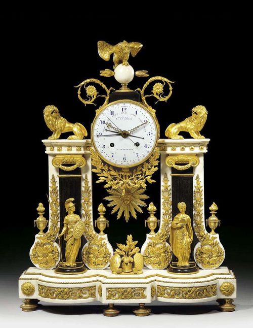 IMPORTANT CLOCK "A DOUBLE COLONNES", Louis XVI, the dial signed CLES JN FERON A VERSAILLES (Charles Feron, active circa 1780), Paris circa 1785. "Carrara" marble and matte and polished gilt bronze. Neo-Classical style portal clock with round case, 2 lions and eagle on sphere, the plinth with "trophées d'armes" between 2 female figures as symbols of "Force" and "Justice". Enamel dial with hours, minutes, seconds, days of the week, date and moon phases, 6 hands, fine verge escapement striking the 1/2 hours on bell. Exceptionally fine matte and polished gilt bronze mounts and applications 58x17x74 cm. Provenance: Private collection, Belgium. A very important clock of perfect quality and elegance. An identical clock with movement signed C. Le Roy was in the collection of M. Ségoura, Paris. A further clock with movement signed Godon Ro de Camara de S.M.C. was sold in our June auction 1997 (Lot No 1175)