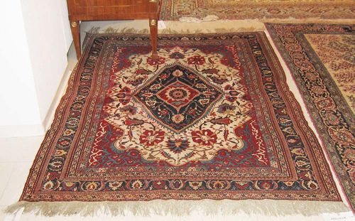 GASHGAI old. Floral central medallion on white ground with red corner motifs, finely patterned with trailing flowers and palmettes. Considerable wear, 182x135 cm.