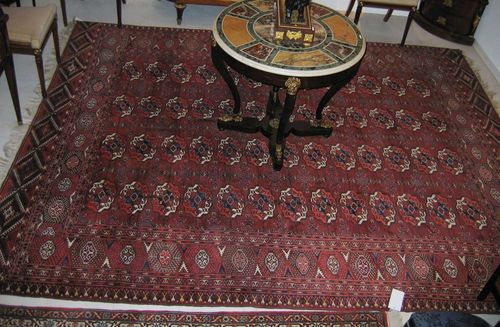 TEKKE BOCHARA antique. Attractive collectors' piece in dark red with four rows of guls. Good condition. 323x259 cm.