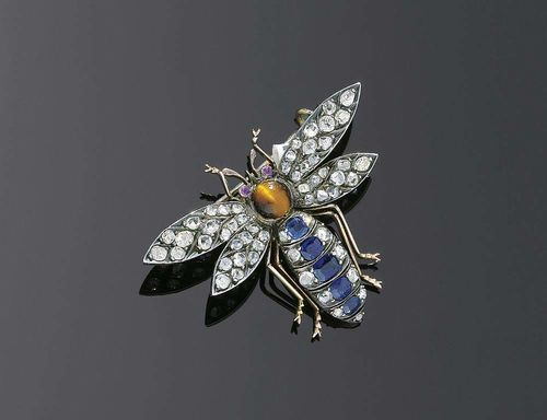 DIAMOND, SAPPHIRE AND TIGER EYE BROOCH, ca. 1890. Silver over yellow gold. Very decorative fly-shaped brooch, the wings set with 46 old-mine-cut diamonds and rose-cut diamonds, the rear body set with 5 antique-oval sapphires totaling ca. 1.00 ct and 11 old-mine-cut diamonds and rose-cut diamonds. The head consists of a round tiger eye cabochon with 2 small rubies as eyes. Diamonds total ca.30 ct. Brooch part is removable.
