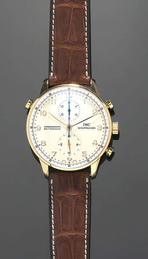 GENTLEMAN'S WRISTWATCH, CHRONO-RATTRAPANTE, IWC PORTUGIESER. Red gold 750. Red gold case No. 2820925 with silver coloured dial, gold numerals and hands, 2 Chrono counters, Ref. 371203, hand winder, Chronograph, Rattrapante. Brown leather strap. Unworn, with case and guarantee 2006. This model is no longer produced.