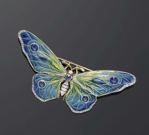 ENAMEL, DIAMOND, SAPPHIRE AND RUBY BROOCH, ca. 1890. Platinum over yellow gold. Very decorative brooch in the shape of a butterfly, the wings are mounted "en tremblant", the body set with 1 oval sapphire and mounted with old-mine-cut diamonds. The wings are in plique-à-jour enamel in blue-green tones, decorated with 4 sapphire cabochons. The wing borders are partially set with diamond roses. Total weight of the sapphires ca. 2.00 ct, the diamonds ca. 1.90 ct. Removable fastener. Probably of French provenance, master craftman's mark illegible.