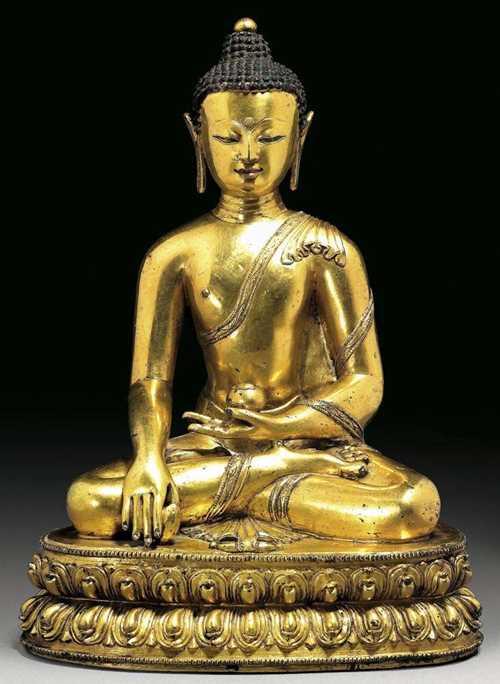 GILT BRONZE FIGURE OF BHAISHAJYAGURU With dark painted hair. The lips with remains of red paint. With finely crafted face. The back of the lotus plinth with remains of halo support. Tibet, 15th century.  H 27.5 cm. From a Swiss private collection