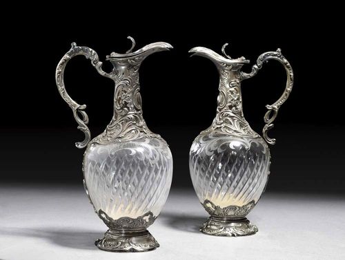 PAIR OF CARAFFES. France, 19th century. Baroque style. Maker's mark CH. Decorated with rocaille and scrolls. With cut glass.