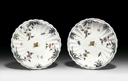PAIR OF BOWLS, Moustier, circa 1750. Ribbed and gadrooned, painted with butterfly and hanging plants in ochre yellow, green and blue. D 24cm (2) Provenance: private collection, South Germany