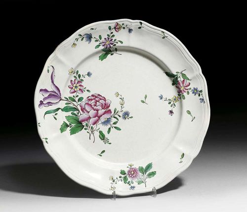 ROUND DISH, Niderviller, Beyerlé, circa 1754-70. Painted with contoured Strassburg style flowers. Mark NB in blue and A for Anstett in black. D 33.5cm. Minor repairs to edge. Provenance: private collection, Lake Geneva
