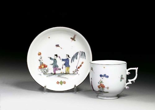 CUP AND SAUCER WITH CHINOISERIE DECORATION, Meissen, circa 1740. Each piece painted in the style of A.F.von Löwenfinck, with two Chinese figures, also Indianische Blumen and a plant. Underglaze blue sword mark and impressed numbers. Invisible restoration on the cup.